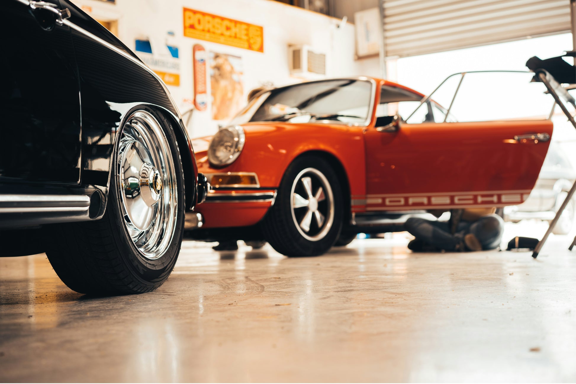Vintage Porsche cars in a showroom setting