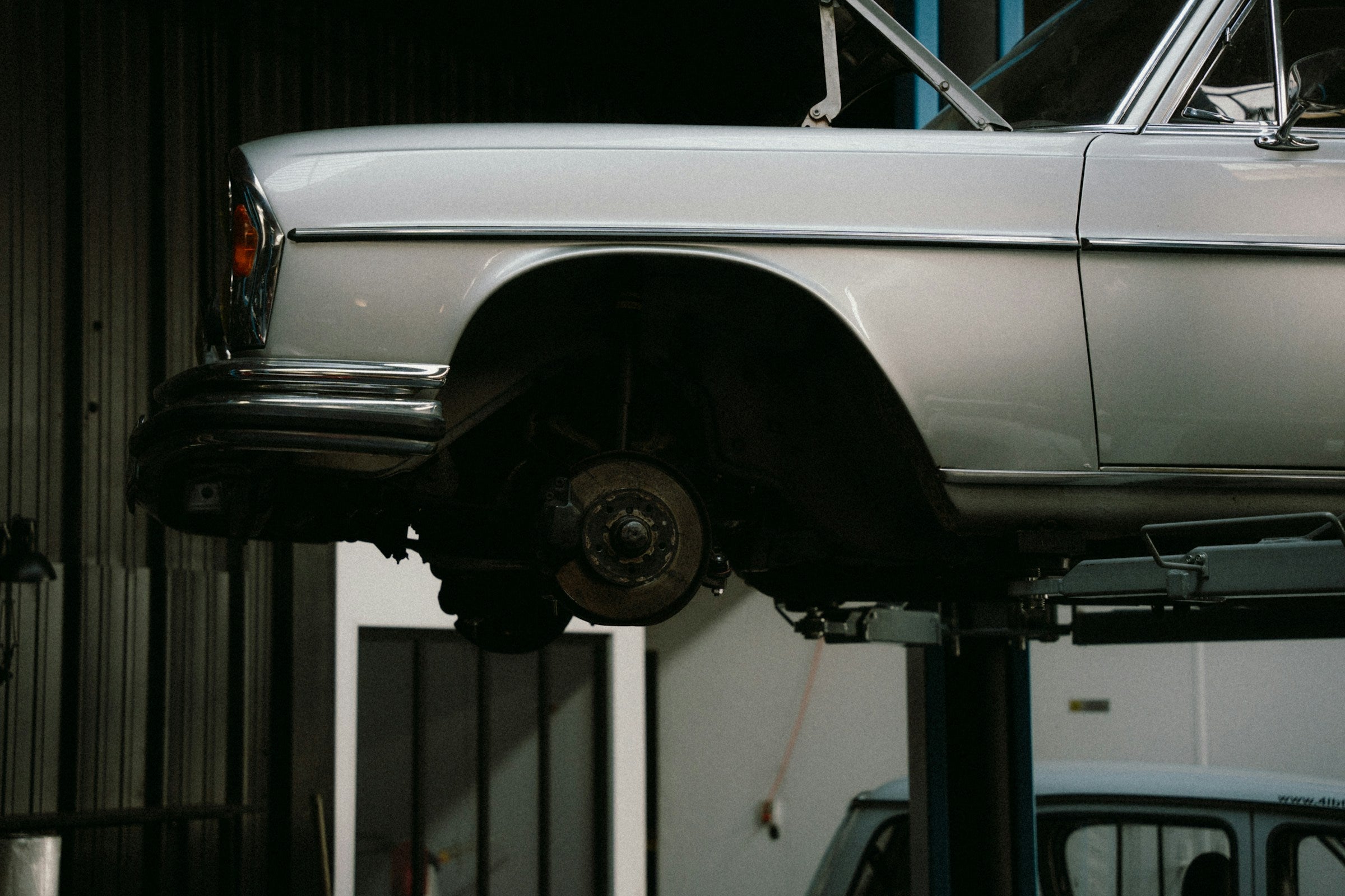 Car on a lift in a garage setting
